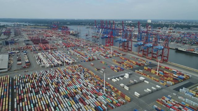 Drone shot flying over container terminal and cranes of Port of Hamburg in Germany