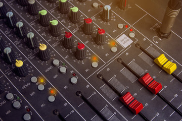 Audio mixing console knobs. Slide Red Control System audio mixer.