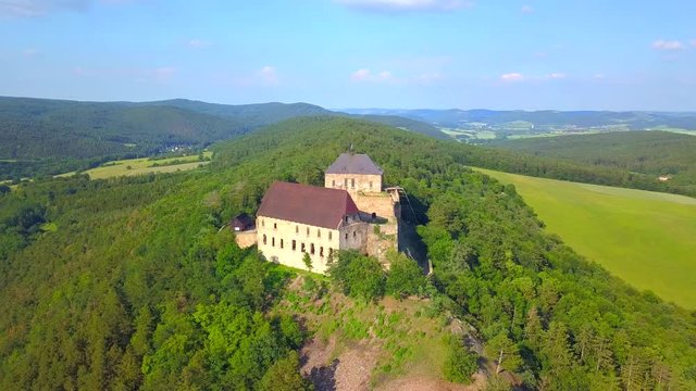 Aerial view of castle Tocnik. Gothic fortress on hill. Famous tourist attractions in Czech republic, European union.
