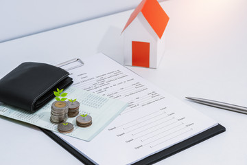 saving account passbook or financial statement, paper house model, and coins with Property Leasing...