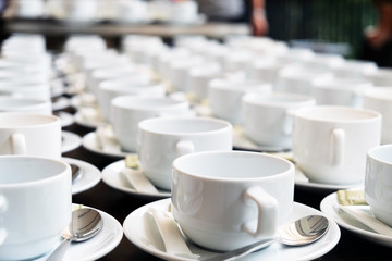 Group of empty cups in many rows of a white cup for coffee in breakfast and seminar event.