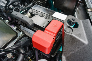 close-up on new small eco car battery installed in the compartment showing good arrangement and...