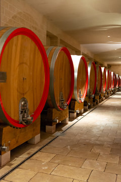 Modern bio wine production factory in Italy, caves with french of americal oak barrels used for aging of wine
