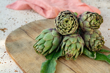 Traditional Italian food, fresh green artichoke vegetables, new harvest, uncooked