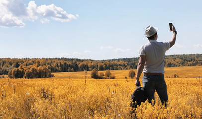 A young man is traveling in nature. Traveling with a backpack on