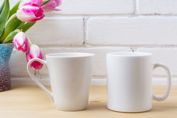 Fototapeta na wymiar White coffee and latte mug mockup with magenta tulip