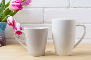 Fototapeta na wymiar White coffee latte and cappuccino mug mockup with magenta tulip