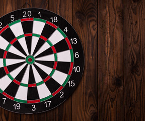 Darts board. Target on wooden table background.