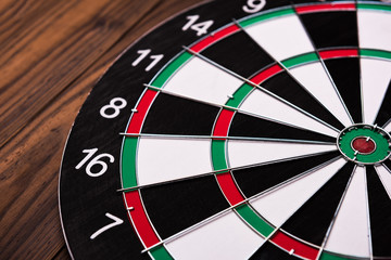 Darts board. Target on wooden table background.