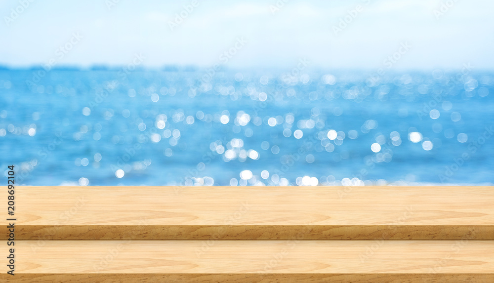 Aufkleber empty plank wood table top with blur blue sky and sea bokeh background,mock up template for display 