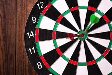 Darts hitting target. Two darts and target