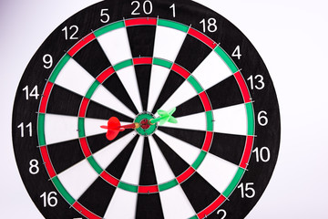Darts hitting target. Two darts and target