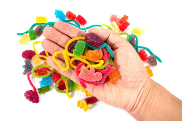 Jelly candy in hand isolated on white background