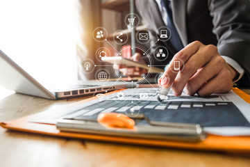 Big data analytics with business intelligence (BI) concept. businessman using mobile phone and laptop computer on white desk with VR chart and graph with icon