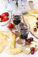 Summer picnic with cheese, wine, fruits and bread. Picnic at the park.