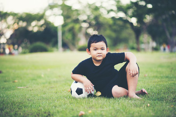 Little Boy playing soccer football