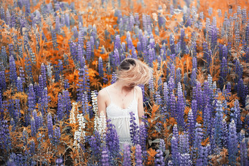 Girl with a bouquet of flowers in autumn