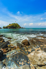 The lighthouse and rocky sand beach with blue sky and daylight on Koh Lanta.