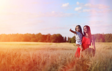 Fototapeta na wymiar Young girl in a wheat field. Summer landscape and a girl on a na