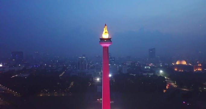 JAKARTA, Indonesia - June 08, 2018: Exotic aerial view of Jakarta National Monument with colorful lights at night. Shot in 4k resolution
