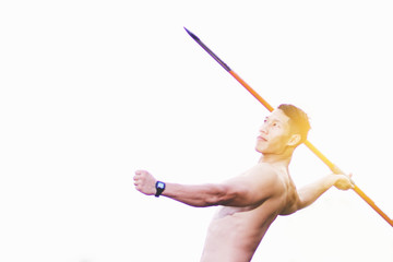 sportsman warming up and practicing javelin throw in yard