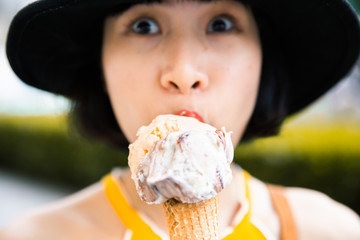 Outdoor closeup fashion portrait of young hipster eating ice cream