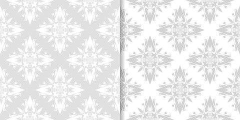 Light gray floral ornaments. Set of seamless patterns