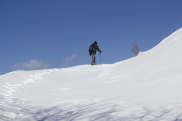 Fototapeta na wymiar hikers walking in the snow in mountain
