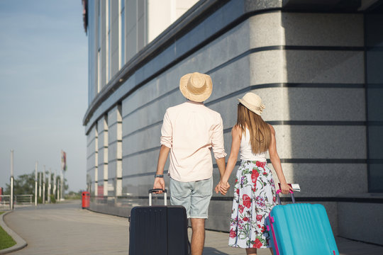 The young couple at the airport and they go on their honeymoon.