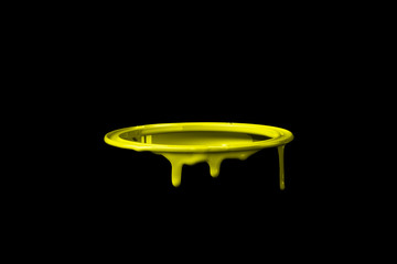 Yellow paint leaking over the wall of empty metal bucket