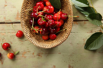 Cherries in a rustic basket and branch