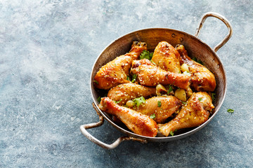 Fried chicken legs with sesame seeds.