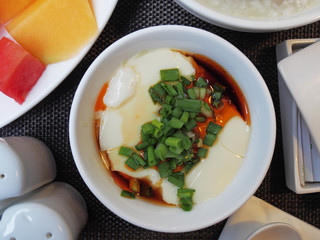 Tofu with  soya sauce on white bowl