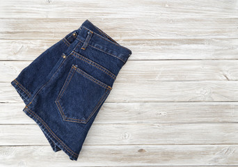 Woman's vintage denim shorts on wooden shelf