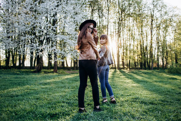 Obraz premium The beautiful sisters walking along park