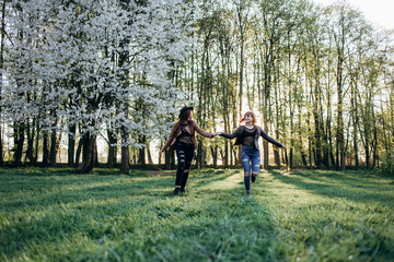 Fototapeta premium The beautiful sisters walking along park