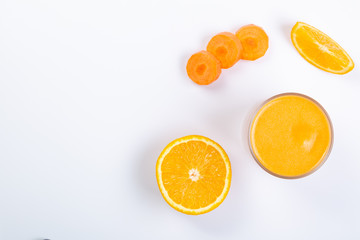 Creative layout of fresh orange and carrot smoothie
