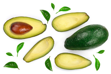 whole and half avocado decorated with green leaves isolated on white background. Top view. Flat lay