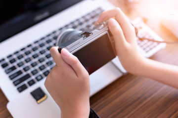 Digital camera  in boy hand ,Camera Photographer workplace .