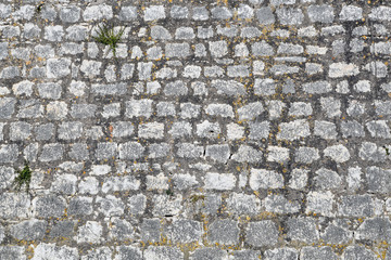 Part of an old grey stone wall, for background or texture. Decorative cracked real stone wall surface with cement.  Antique natural stonewall background