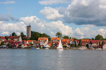 cityscape of Mikolajki with sailing boats on Mikolajskie Lake