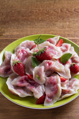 Dumplings, filled with strawberries. Pierogi, varenyky, vareniki, pyrohy - dumplings with filling, popular dish in many countries