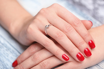 Woman wearing beautiful engagement ring, closeup