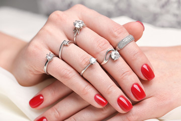 Woman wearing many different engagement rings, closeup