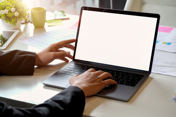 Businessman hands using laptop at office desk