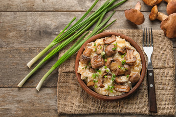 Composition with delicious risotto on wooden background, top view