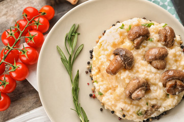 Tasty risotto with mushrooms on plate, closeup