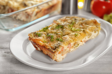 Plate with tasty broccoli casserole on table. Fresh from oven