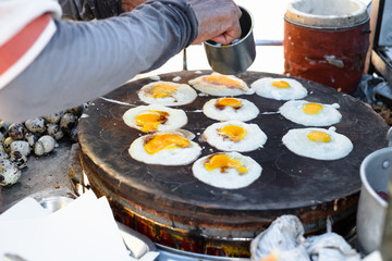 Confectioner break the eggs on flour making roll pancake stuffed with pork. Street food and dessert in Thailand.