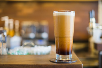 Cappuccino layer coffee on wooden table background.